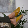 Load image into Gallery viewer, Leather handmade Egyptian slippers, mustard yellow leather on top and tan leather sole, white hand stitching through the yellow leather, pointed toe and flat sole