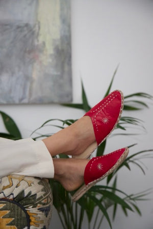 Leather handmade Egyptian slippers, ruby red leather on top and tan leather sole, white hand stitching through the red leather, pointed toe and flat sole
